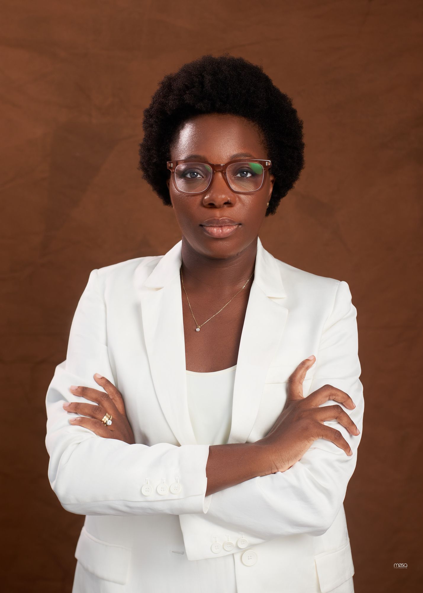Olafemiwa Okanla, freelance senior consultant, in a white blazer and glasses